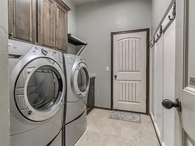 laundry area with washer and clothes dryer and cabinet space