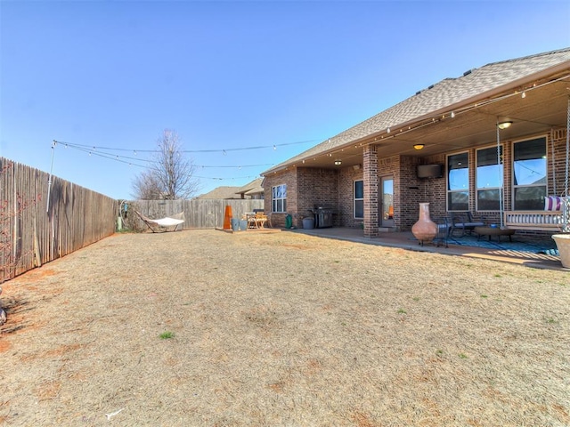 view of yard with a patio area and a fenced backyard