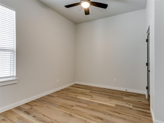 spare room with light wood-style floors, ceiling fan, and baseboards