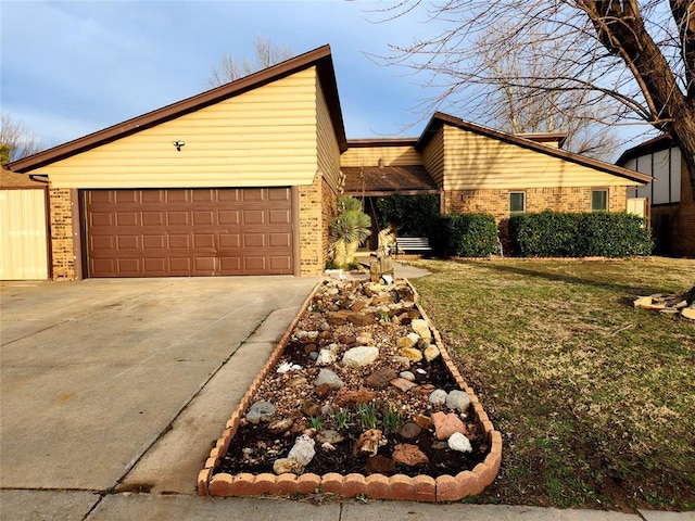 view of front of house featuring a garage, driveway, brick siding, and a front lawn