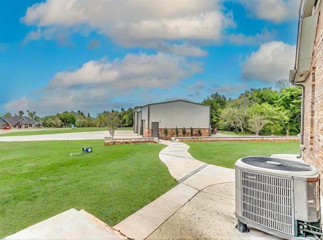 view of yard with central air condition unit and a patio area