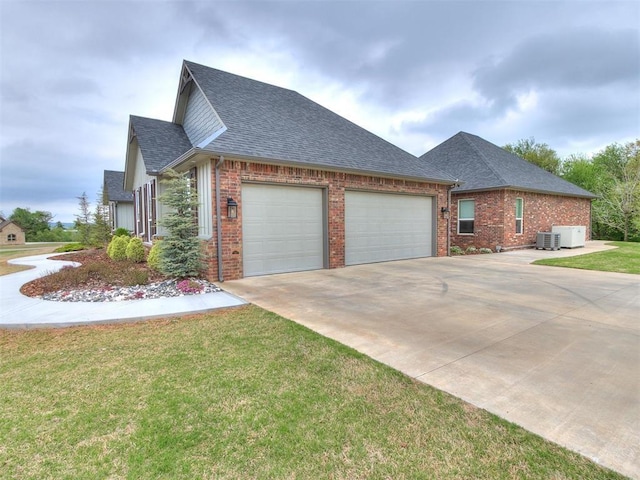 view of side of home with brick siding, a shingled roof, concrete driveway, a lawn, and a garage