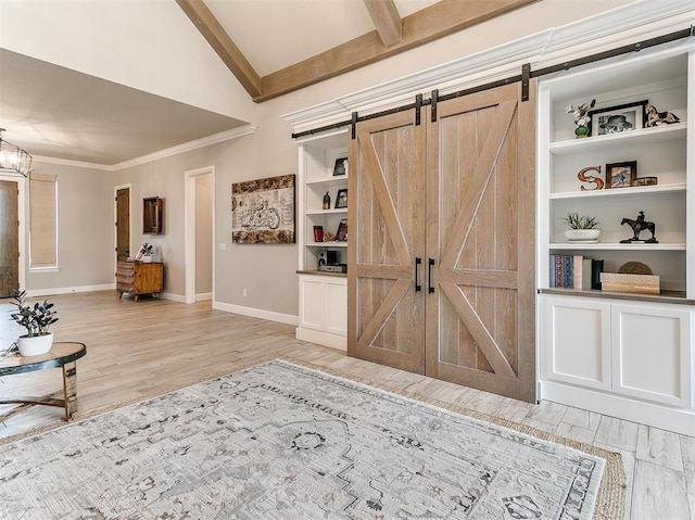 entrance foyer featuring a barn door, light wood-style floors, and baseboards