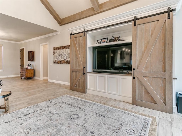 unfurnished living room with ornamental molding, lofted ceiling with beams, a barn door, light wood-style floors, and baseboards