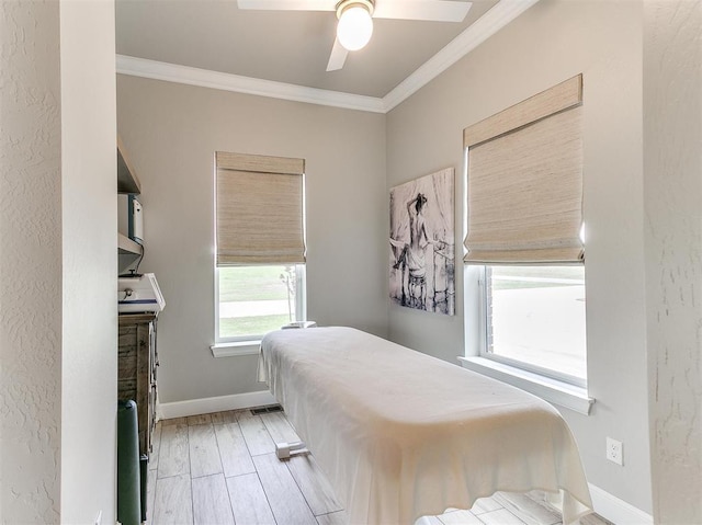 bedroom featuring baseboards, a ceiling fan, wood finished floors, and crown molding