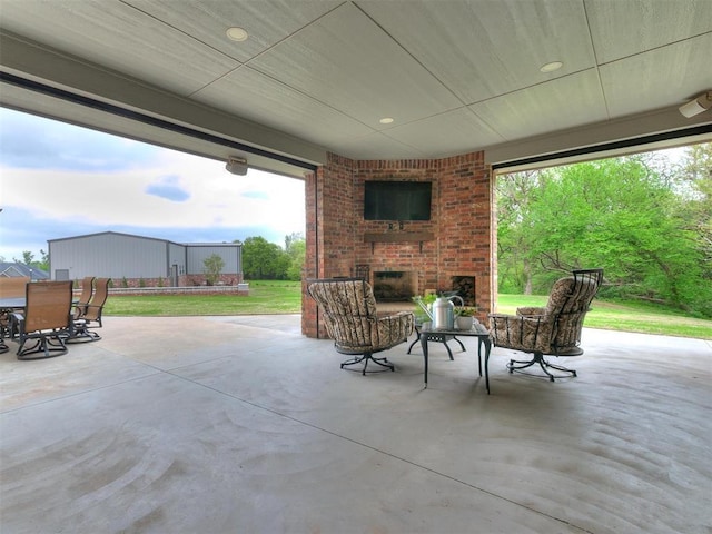 view of patio / terrace with an outdoor brick fireplace