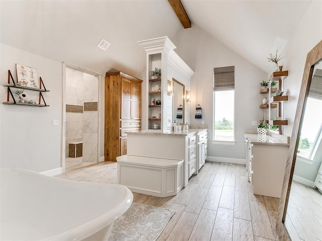 bathroom featuring vanity, wood tiled floor, lofted ceiling with beams, a soaking tub, and a walk in shower