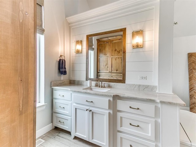 bathroom with vanity, visible vents, and baseboards