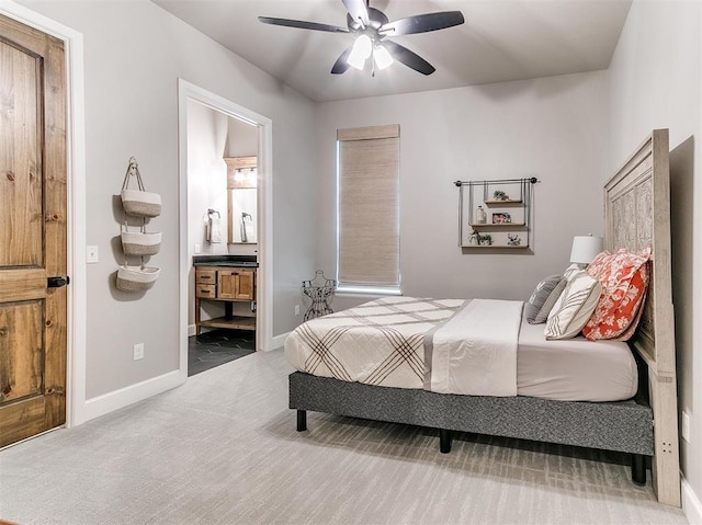 carpeted bedroom featuring a ceiling fan, baseboards, and connected bathroom