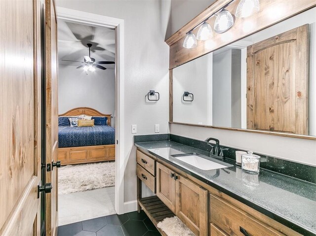 bathroom featuring connected bathroom, ceiling fan, vanity, and tile patterned flooring