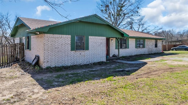 single story home featuring fence and brick siding