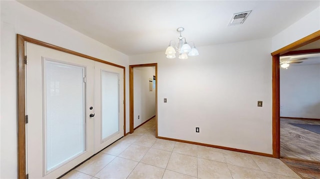 interior space with a chandelier, visible vents, baseboards, and light tile patterned floors