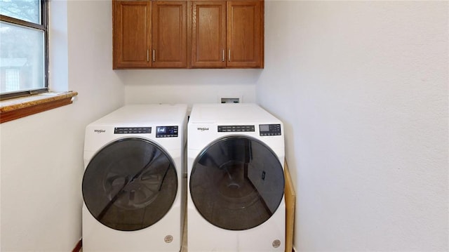 laundry room featuring washing machine and dryer and cabinet space