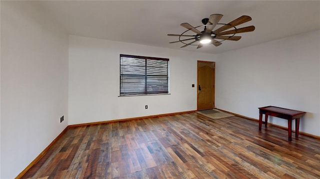 unfurnished room with a ceiling fan, baseboards, and wood finished floors