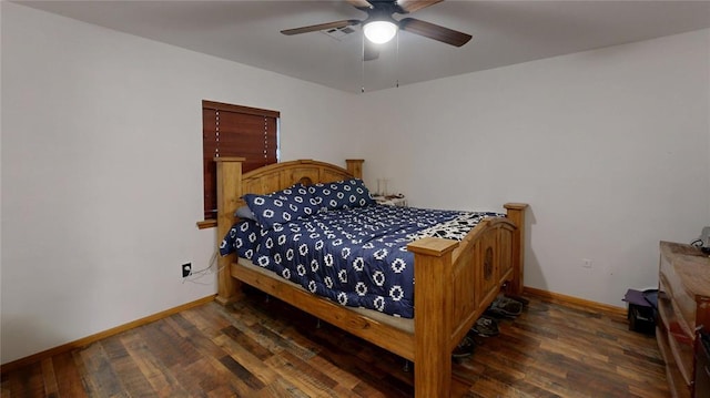 bedroom featuring a ceiling fan, baseboards, and wood finished floors