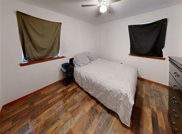 bedroom featuring ceiling fan, wood-type flooring, and baseboards