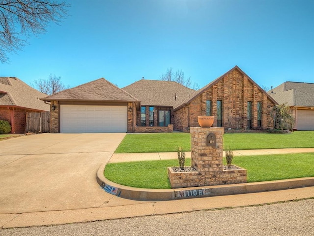 view of front facade featuring brick siding, roof with shingles, a garage, driveway, and a front lawn