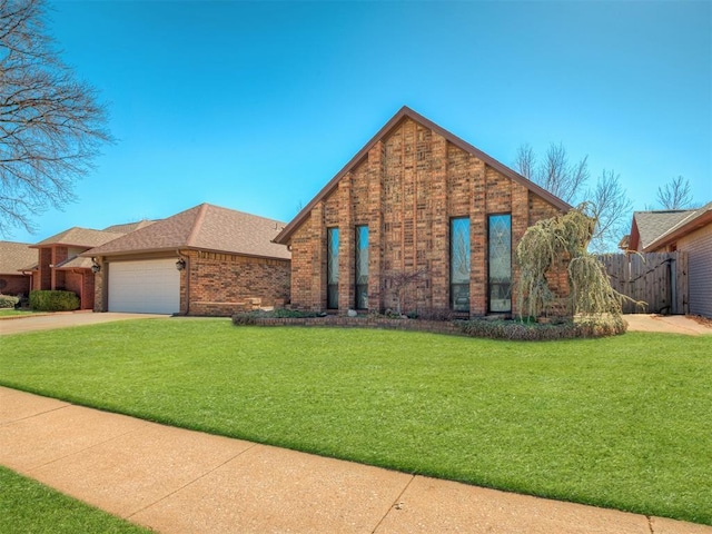 view of front facade featuring driveway, brick siding, an attached garage, fence, and a front yard