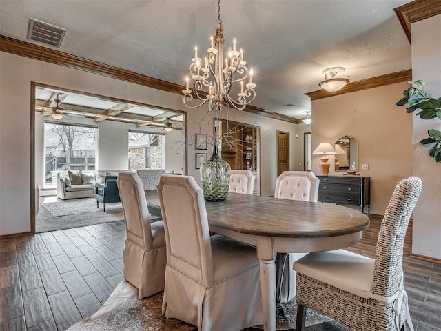 dining space featuring a ceiling fan, visible vents, crown molding, and wood finish floors