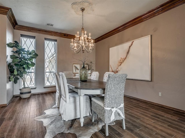 dining room with ornamental molding, dark wood-style flooring, visible vents, and a chandelier