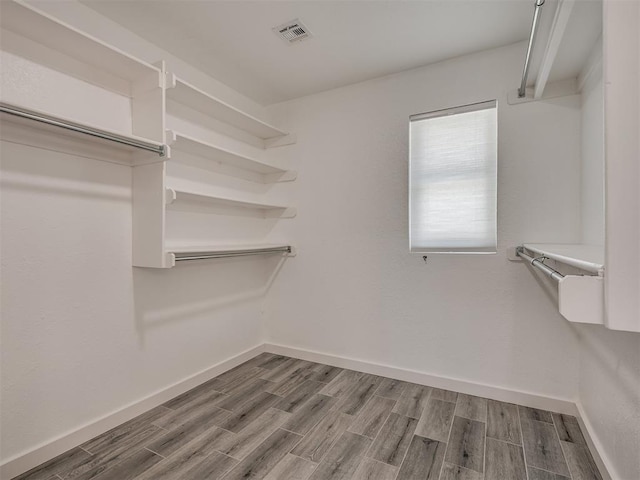 walk in closet featuring wood tiled floor and visible vents