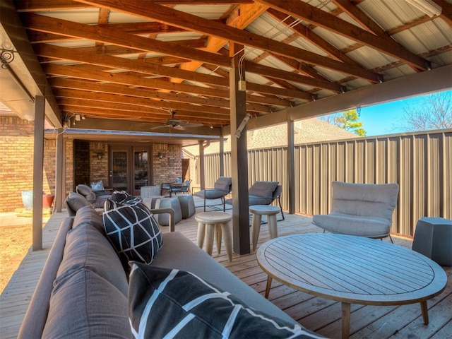 view of patio / terrace with french doors, a ceiling fan, outdoor dining space, fence, and a deck