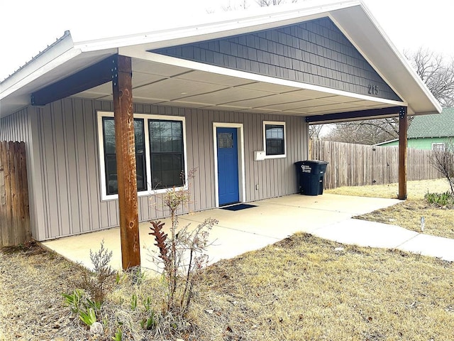 exterior space featuring board and batten siding and fence