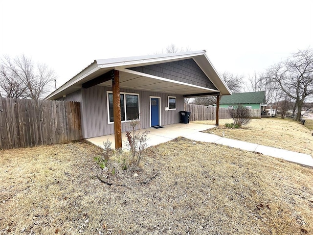 view of front of home with a patio and fence