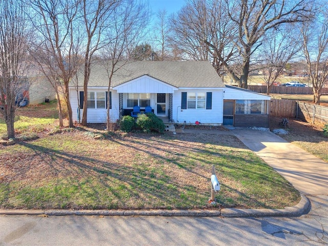 420 W Lincoln St, Purcell, OK 73080 - view of front of home featuring roof with shingles, fence, concrete driveway, and a front yard