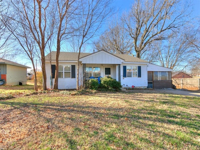 420 W Lincoln St, Purcell, OK 73080 - view of front of house with board and batten siding, a front yard, and fence