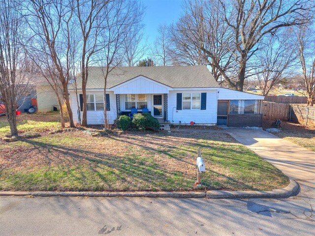 420 W Lincoln St, Purcell, OK 73080 - view of front of home with a shingled roof, concrete driveway, fence, and a front lawn