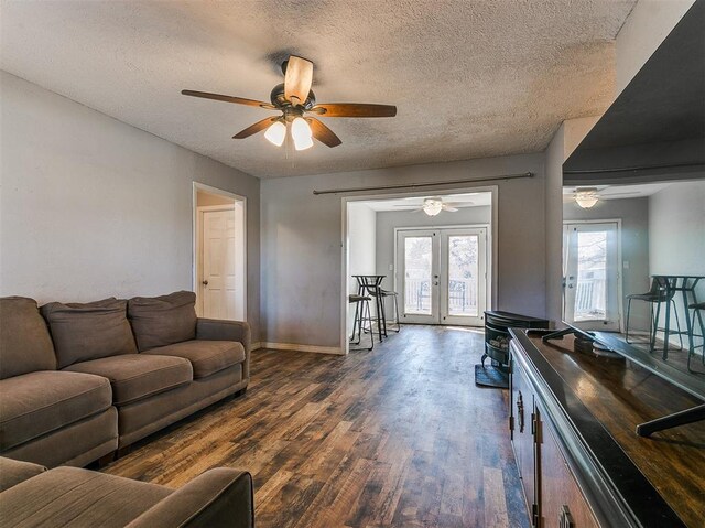 420 W Lincoln St, Purcell, OK 73080 - living room with a textured ceiling, baseboards, wood finished floors, and french doors