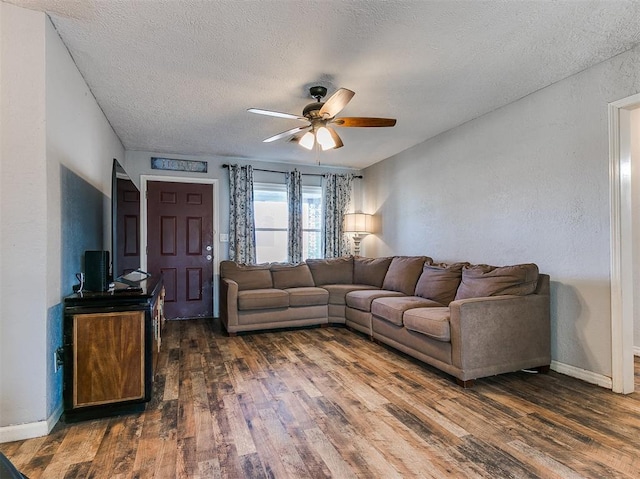 420 W Lincoln St, Purcell, OK 73080 - living room featuring dark wood-style floors, ceiling fan, a textured ceiling, and baseboards
