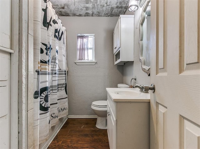420 W Lincoln St, Purcell, OK 73080 - full bathroom with a textured wall, toilet, vanity, wood finished floors, and a shower with curtain