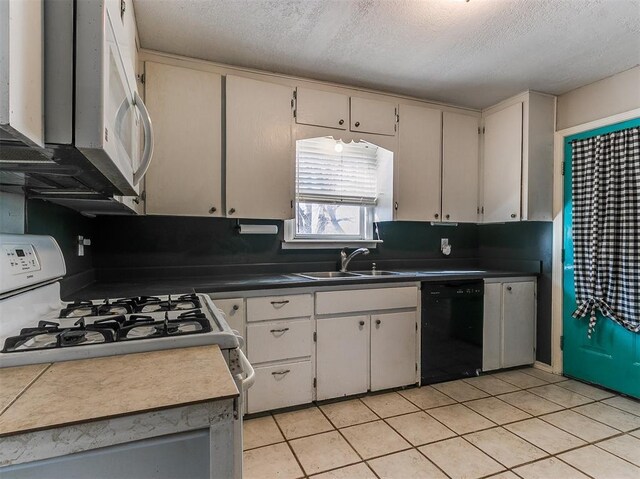 420 W Lincoln St, Purcell, OK 73080 - kitchen featuring white appliances, a sink, a textured ceiling, and light tile patterned floors