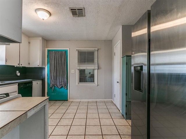 420 W Lincoln St, Purcell, OK 73080 - kitchen with light tile patterned flooring, white cabinetry, visible vents, black dishwasher, and stainless steel fridge with ice dispenser