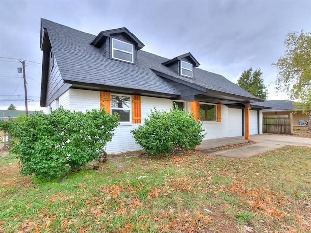 view of front facade featuring concrete driveway, brick siding, an attached garage, and a shingled roof