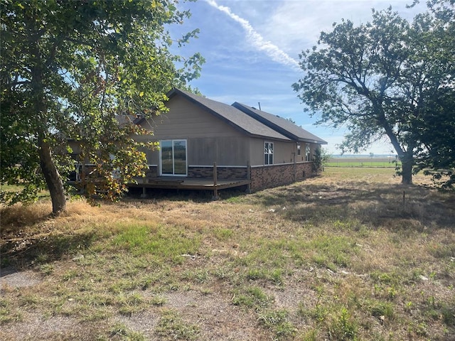 29094 County St Unit 2530, Fort Cobb, OK 73038 - view of side of property with brick siding, fence, and a wooden deck