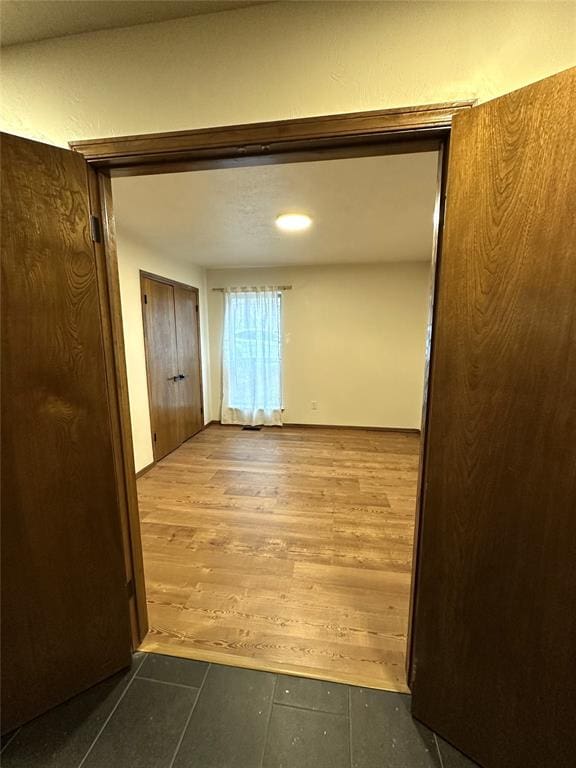 corridor featuring wood finished floors