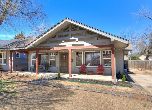 view of front of house featuring a patio area and fence