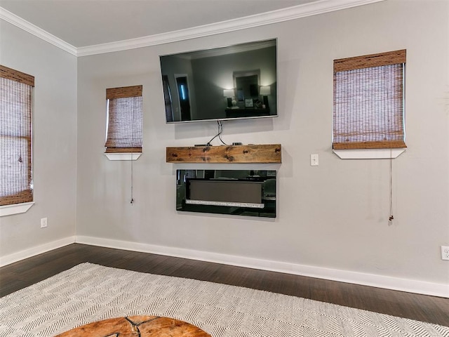 unfurnished living room with baseboards, wood finished floors, and ornamental molding