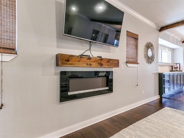 living room with baseboards, wood finished floors, and crown molding