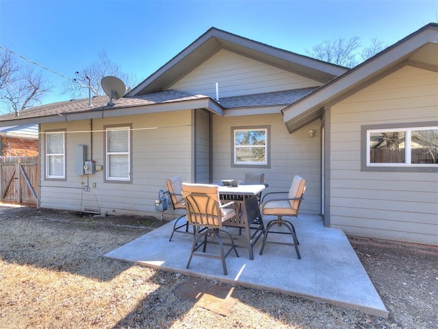 view of patio featuring outdoor dining space and fence