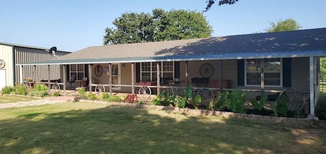 rear view of property with a porch and a lawn