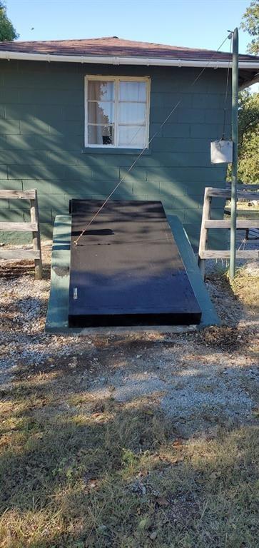 entry to storm shelter with fence