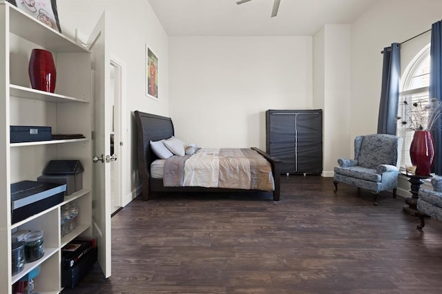 bedroom with baseboards and wood finished floors