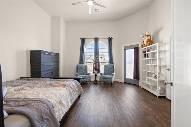 bedroom featuring a ceiling fan, baseboards, visible vents, and wood finished floors