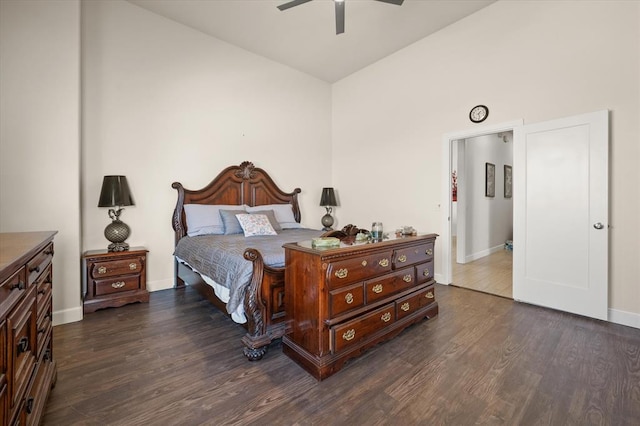 bedroom with lofted ceiling, ceiling fan, dark wood finished floors, and baseboards