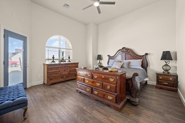 bedroom with lofted ceiling, baseboards, visible vents, and wood finished floors