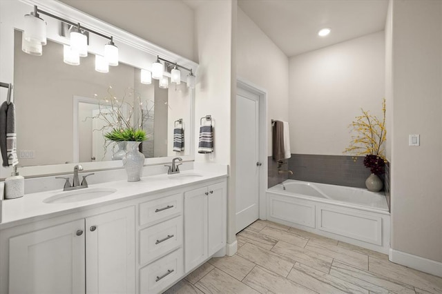 full bathroom with a sink, a bath, and double vanity